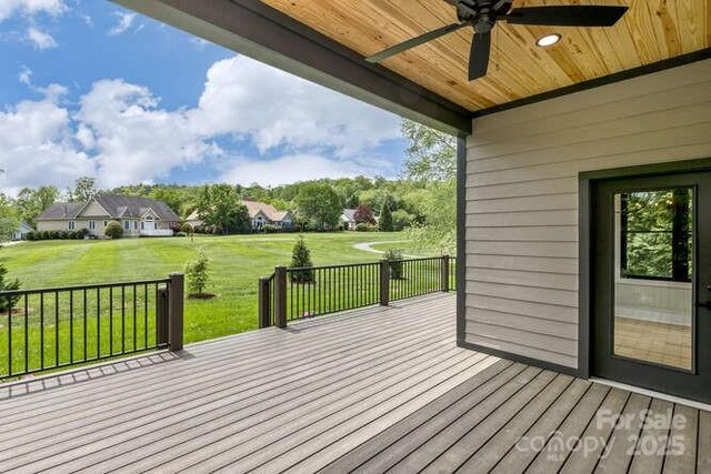 deck with ceiling fan and a yard