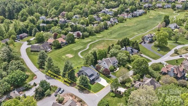 drone / aerial view featuring a residential view and view of golf course
