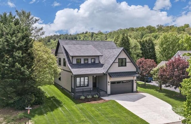 19 Fairway Falls Rd, Mills River, NC 28759 - view of front of property with a porch, a wooded view, driveway, and a front yard