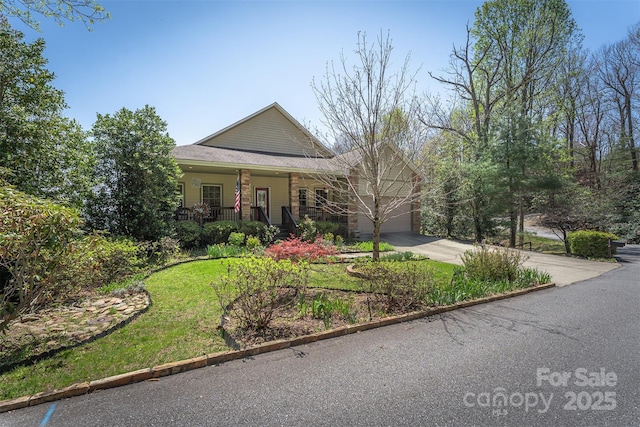 172 Sunny Ridge Rd, Hendersonville, NC 28739 - view of front facade featuring concrete driveway, a front yard, a garage, and covered porch