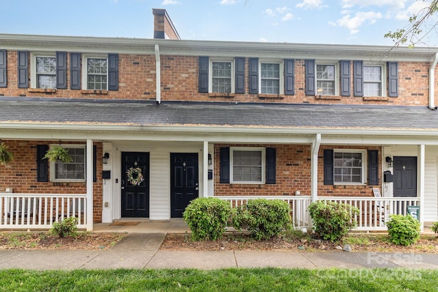 view of front of property with covered porch and brick siding