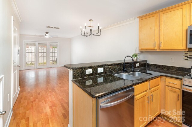 kitchen with visible vents, appliances with stainless steel finishes, light wood-style flooring, and a sink