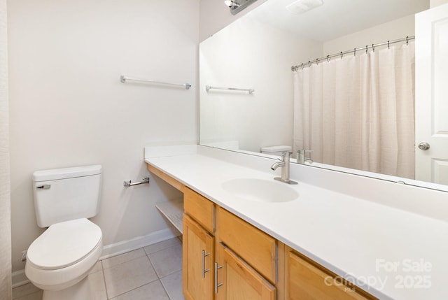 bathroom with baseboards, toilet, and tile patterned flooring