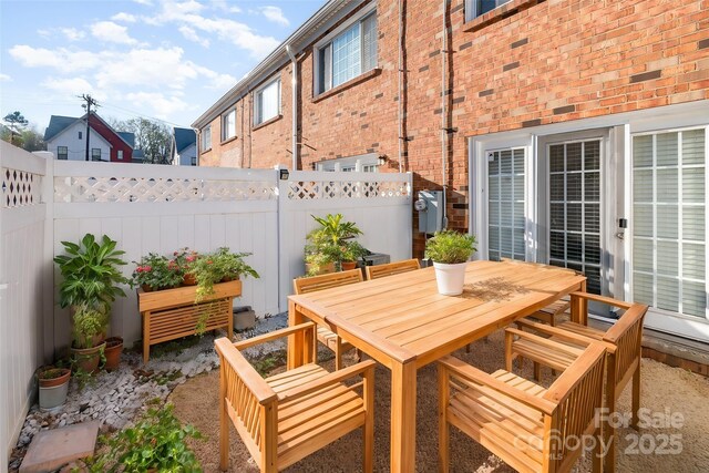 view of patio with outdoor dining area and a fenced backyard