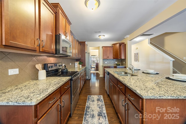 352 Nantucket Way, Rock Hill, SC 29732 - kitchen featuring appliances with stainless steel finishes, a sink, decorative backsplash, dark wood-type flooring, and light stone counters