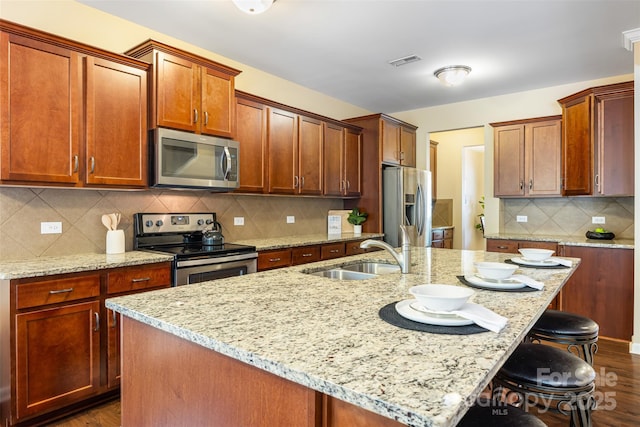 352 Nantucket Way, Rock Hill, SC 29732 - kitchen featuring stainless steel appliances, a sink, a breakfast bar area, and light stone countertops