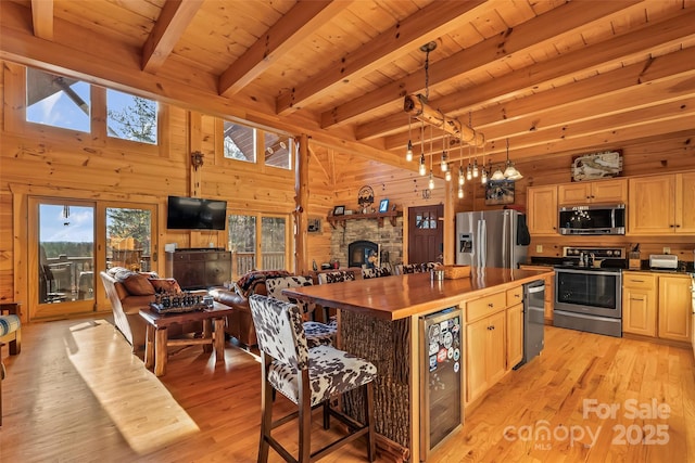 1600 Pisgah Preserve Dr, Nebo, NC 28761 - kitchen with wine cooler, wooden ceiling, wooden walls, open floor plan, and stainless steel appliances