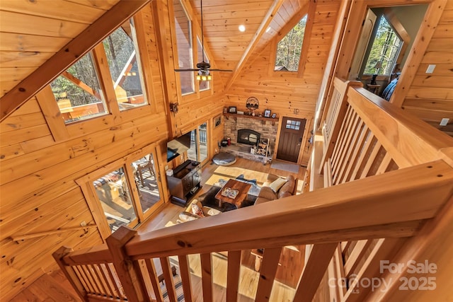 1600 Pisgah Preserve Dr, Nebo, NC 28761 - stairs with high vaulted ceiling, wood walls, a fireplace, beam ceiling, and wood ceiling