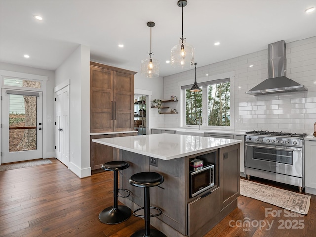 322 Windswept Dr, Asheville, NC 28801 - kitchen featuring open shelves, wall chimney range hood, dark wood-type flooring, light countertops, and appliances with stainless steel finishes