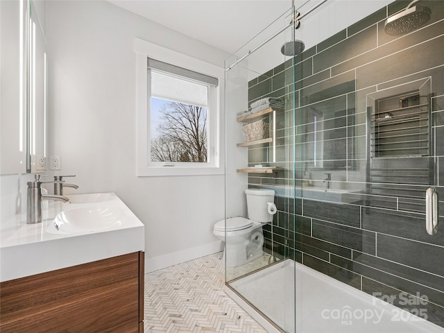 322 Windswept Dr, Asheville, NC 28801 - bathroom with double vanity, a shower stall, a sink, baseboards, and toilet