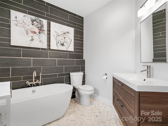 322 Windswept Dr, Asheville, NC 28801 - full bath featuring vanity, toilet, a freestanding tub, tile walls, and baseboards