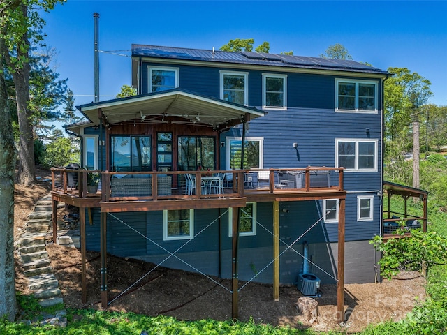 322 Windswept Dr, Asheville, NC 28801 - rear view of house with ceiling fan, a wooden deck, and roof mounted solar panels