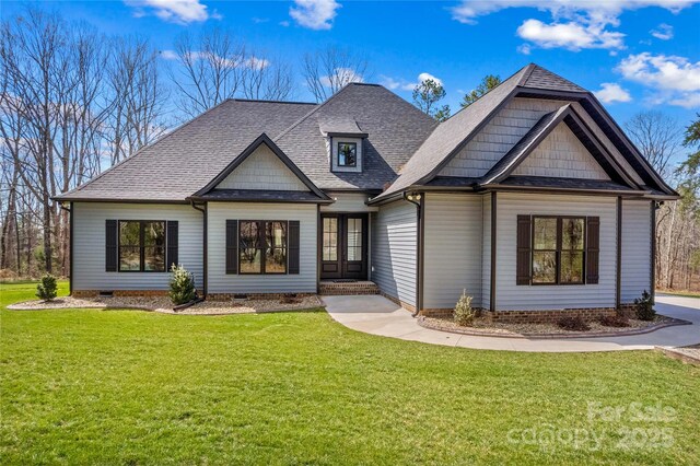 view of front of home with a shingled roof, a front lawn, and crawl space