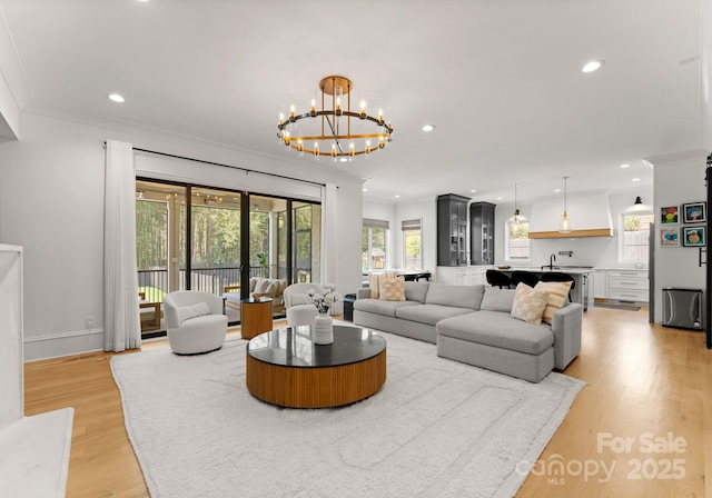 300 Mammoth Oaks Dr, Charlotte, NC 28270 - living area featuring a chandelier, ornamental molding, recessed lighting, light wood-style floors, and baseboards