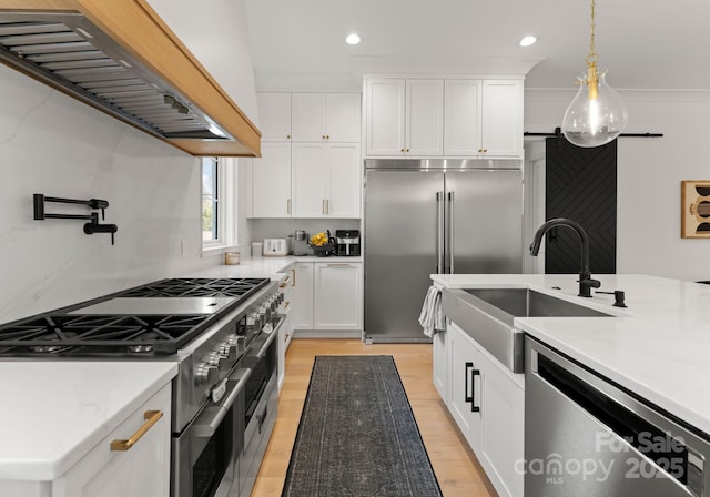 300 Mammoth Oaks Dr, Charlotte, NC 28270 - kitchen featuring high end appliances, custom range hood, a sink, recessed lighting, and light wood-type flooring
