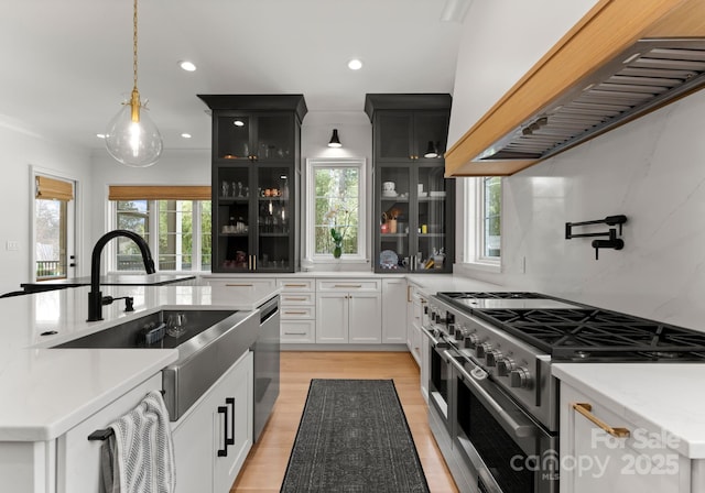 300 Mammoth Oaks Dr, Charlotte, NC 28270 - kitchen featuring premium range hood, appliances with stainless steel finishes, glass insert cabinets, hanging light fixtures, and recessed lighting