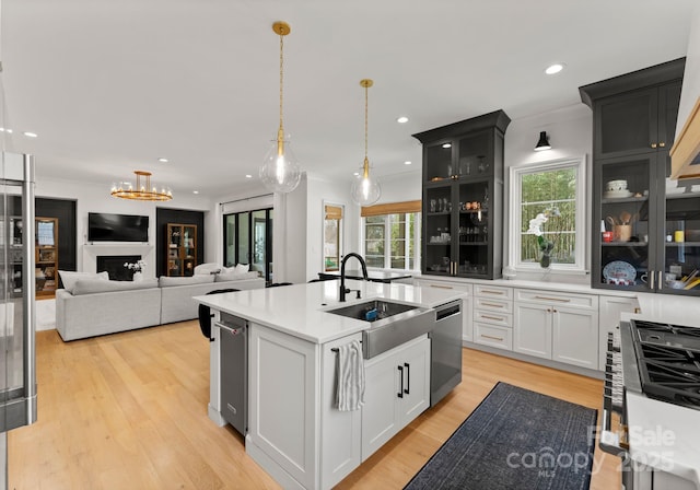 300 Mammoth Oaks Dr, Charlotte, NC 28270 - kitchen with a sink, dishwasher, pendant lighting, glass insert cabinets, and a kitchen island with sink