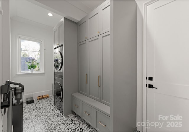 300 Mammoth Oaks Dr, Charlotte, NC 28270 - laundry room featuring cabinet space, stacked washer and clothes dryer, recessed lighting, baseboards, and tile patterned floors