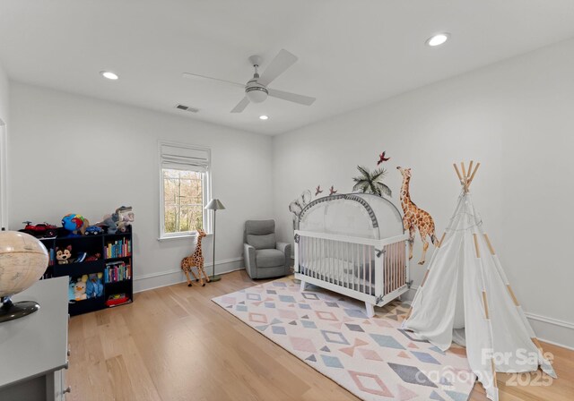 300 Mammoth Oaks Dr, Charlotte, NC 28270 - bedroom featuring wood finished floors, a ceiling fan, recessed lighting, baseboards, and a nursery area