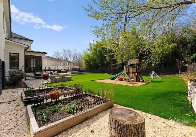 300 Mammoth Oaks Dr, Charlotte, NC 28270 - view of yard featuring a playground, a sunroom, a patio area, and a vegetable garden