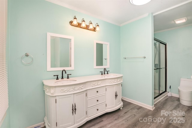 400 E 1st St, Cherryville, NC 28021 - bathroom with wood finished floors, toilet, ornamental molding, a shower stall, and double vanity
