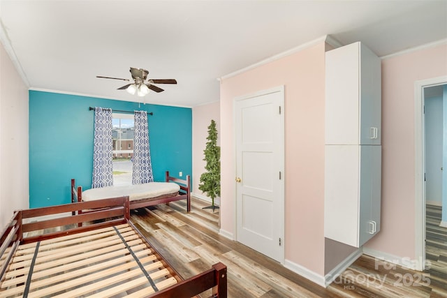400 E 1st St, Cherryville, NC 28021 - bedroom with ornamental molding, light wood-type flooring, baseboards, and ceiling fan