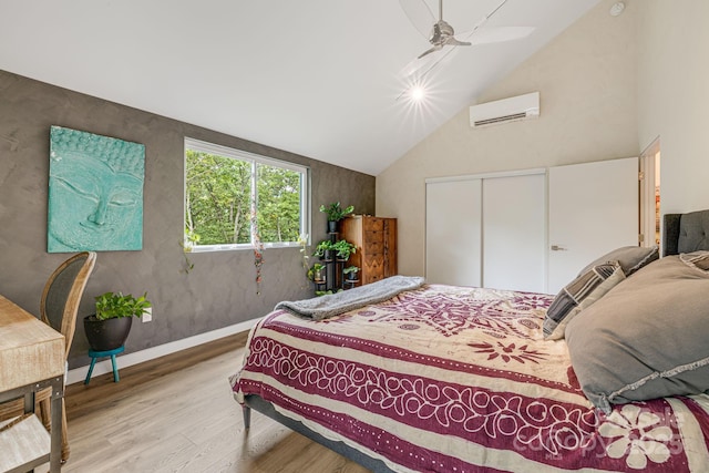 47 Webb Cove Rd, Asheville, NC 28804 - bedroom featuring a wall mounted AC, wood finished floors, a closet, baseboards, and ceiling fan