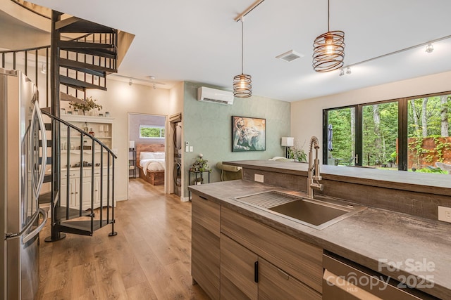 47 Webb Cove Rd, Asheville, NC 28804 - kitchen with a sink, stainless steel appliances, plenty of natural light, and light wood-type flooring