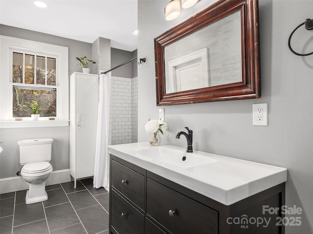 bathroom featuring toilet, curtained shower, tile patterned flooring, baseboards, and vanity