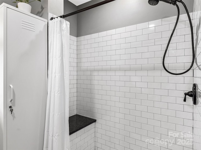 bathroom with a tile shower