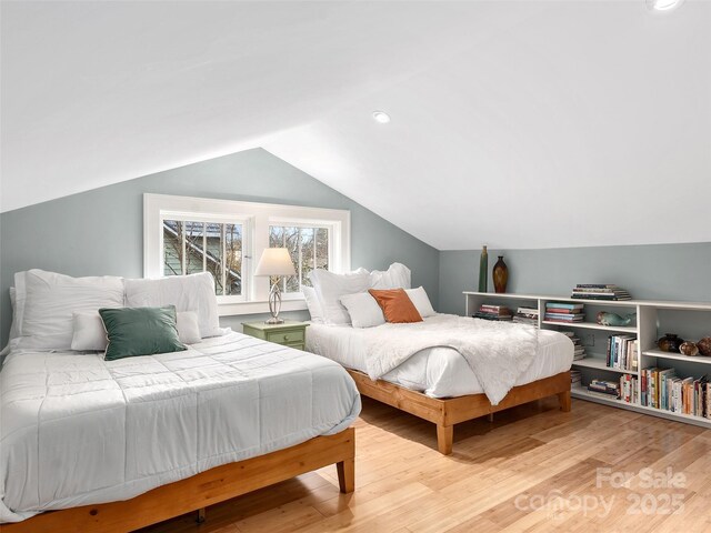 bedroom featuring recessed lighting, lofted ceiling, and wood finished floors