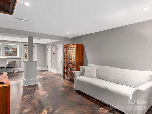 living room featuring recessed lighting, visible vents, baseboards, and finished concrete floors