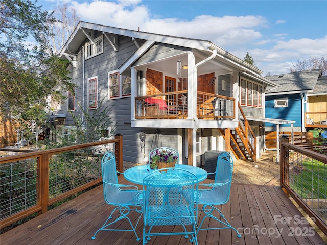 wooden deck with stairs and outdoor dining area