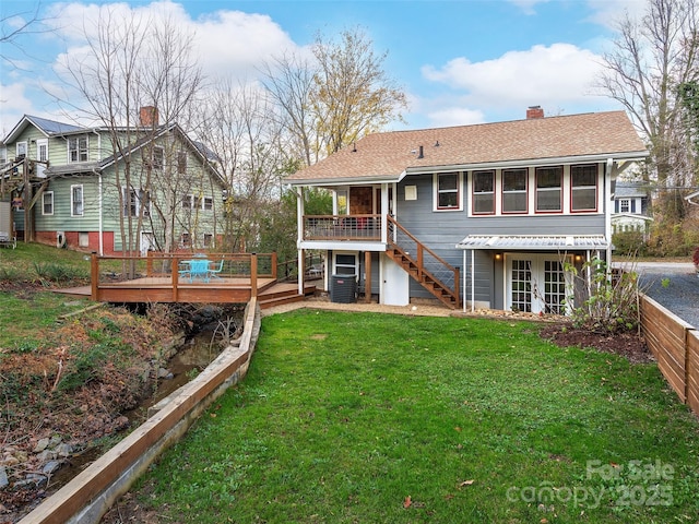back of property featuring roof with shingles, french doors, a chimney, a yard, and a deck