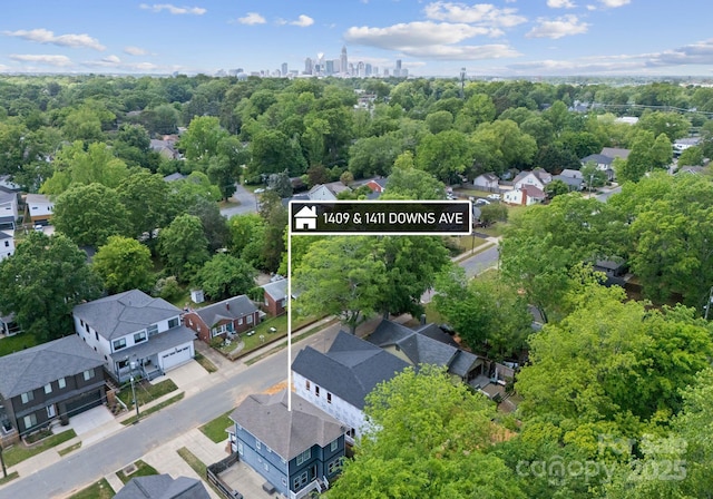 aerial perspective of suburban area with property boundaries highlighted and a tree filled landscape