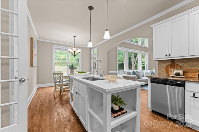 kitchen featuring open shelves, stainless steel dishwasher, a sink, and ornamental molding