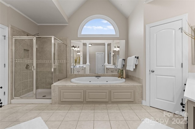 bathroom with a shower stall, tile patterned flooring, vaulted ceiling, vanity, and a garden tub