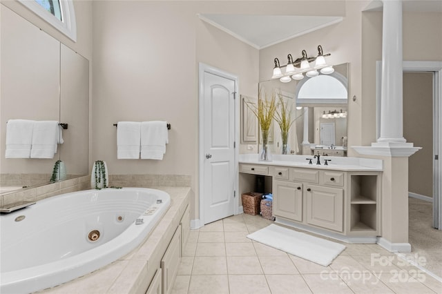 full bathroom featuring vanity, a jetted tub, tile patterned flooring, and decorative columns