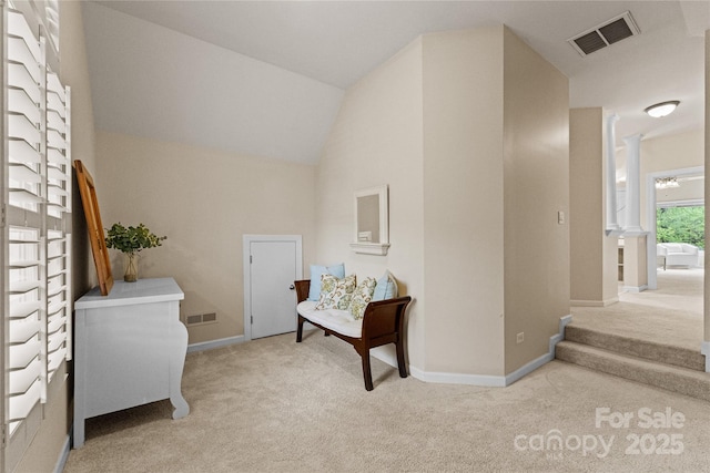 sitting room featuring carpet floors, lofted ceiling, visible vents, and baseboards