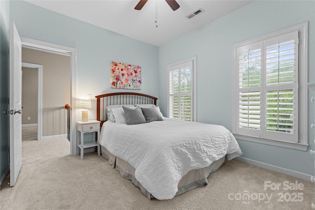carpeted bedroom with ceiling fan, baseboards, and visible vents