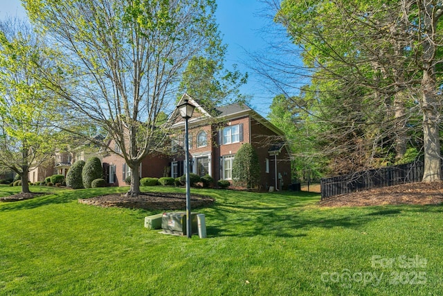 exterior space with fence and a yard