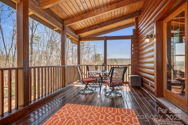 wooden terrace with outdoor dining space