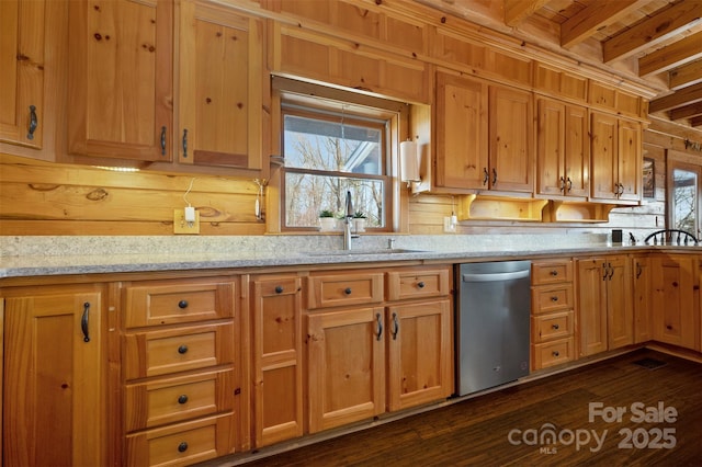 kitchen featuring a sink, light stone counters, beamed ceiling, and dark wood finished floors