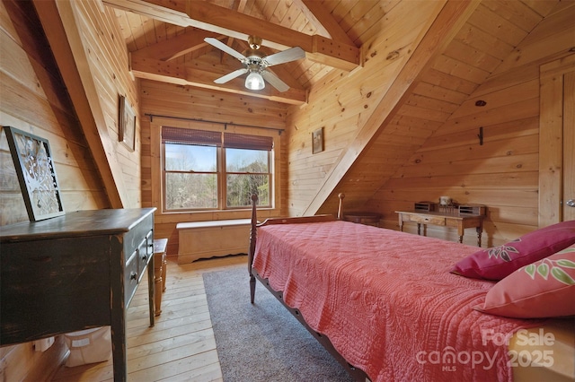 bedroom with lofted ceiling with beams, light wood-style flooring, wood walls, and wood ceiling