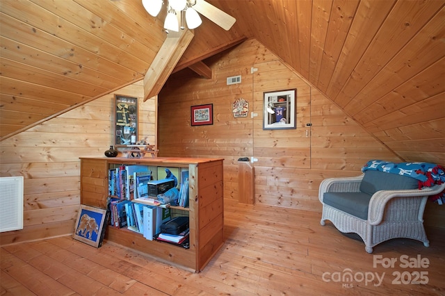interior space with wood walls, wood ceiling, and hardwood / wood-style floors