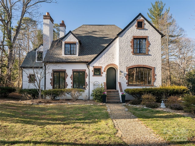 view of front facade featuring a front lawn and a chimney