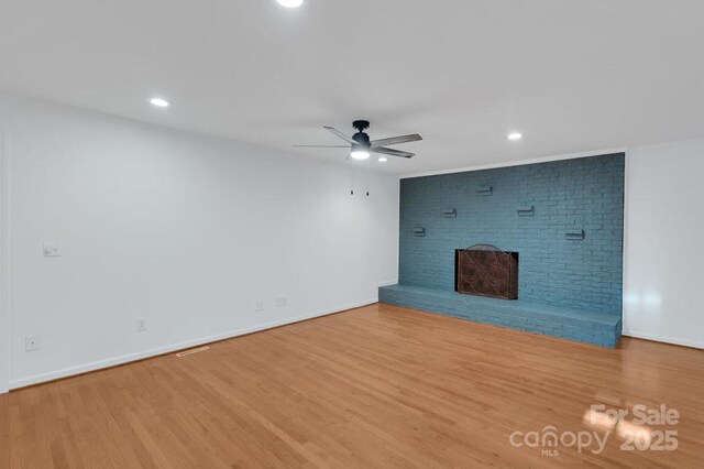 2750 Morgan Rd, Gold Hill, NC 28071 - unfurnished living room with a ceiling fan, wood finished floors, baseboards, recessed lighting, and a brick fireplace