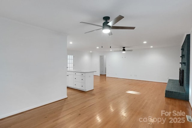 2750 Morgan Rd, Gold Hill, NC 28071 - unfurnished living room with baseboards, light wood-style floors, and a ceiling fan