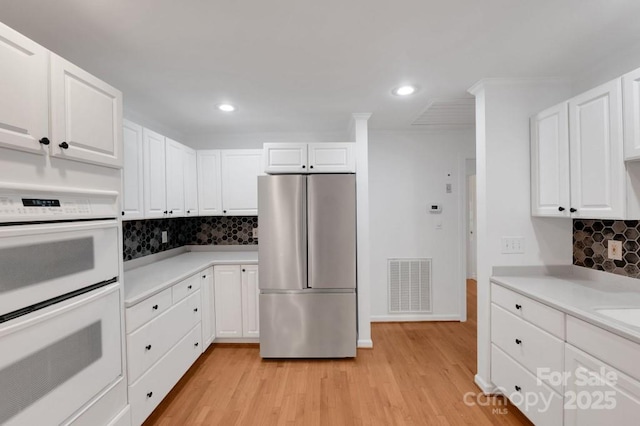 2750 Morgan Rd, Gold Hill, NC 28071 - kitchen with visible vents, freestanding refrigerator, light countertops, white cabinets, and double oven