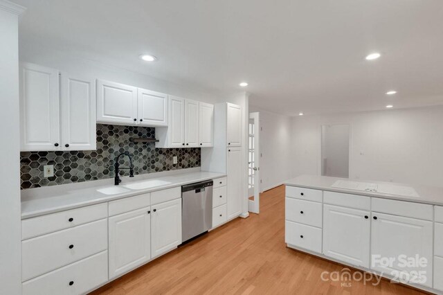 2750 Morgan Rd, Gold Hill, NC 28071 - kitchen with a sink, light countertops, white cabinets, dishwasher, and light wood-type flooring